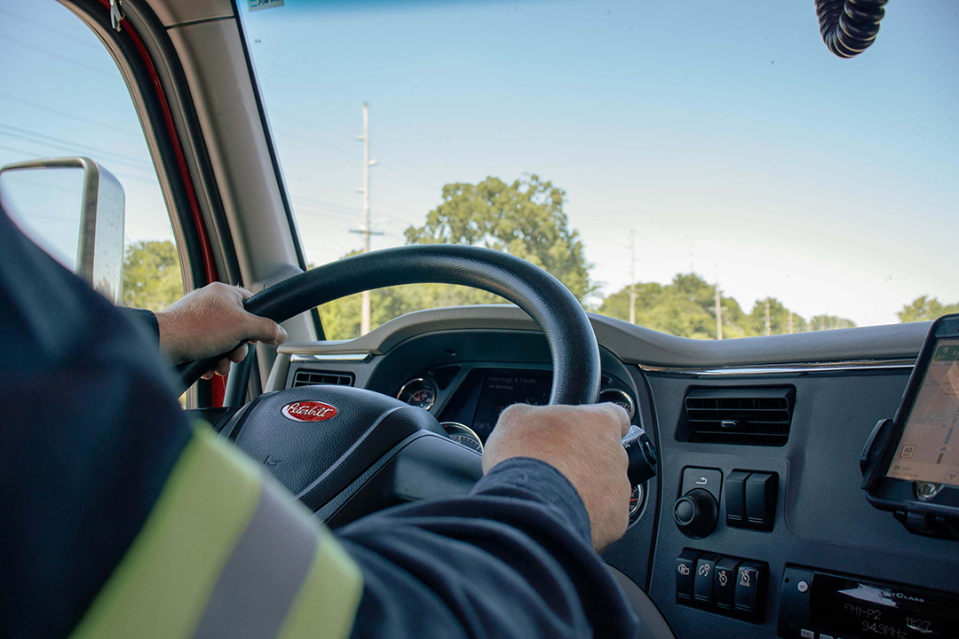 Truck Driver holding steering wheel
